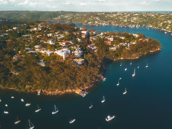 Drone image of houses and private boats over the Sailors Bay - Linden Way Reserve